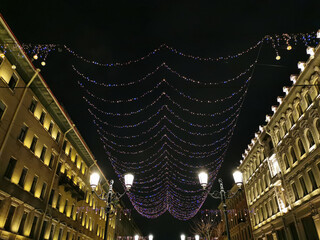 Festive illumination for Christmas and New Year on Malaya Konyushennaya Street in St. Petersburg on an early winter morning
