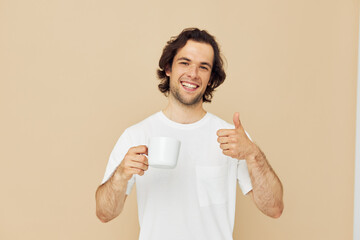 Attractive man with a white mug in his hands emotions posing isolated background