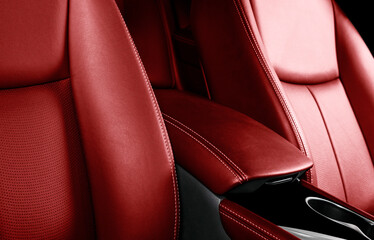 Luxury car red leather interior. Part of leather car seat details with stitching. Comfortable...