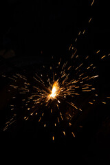 Close-up of welding, Sparks from the welding deode fly away in different directions during...