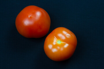Whole tomatoes on the table. Fresh vegetables