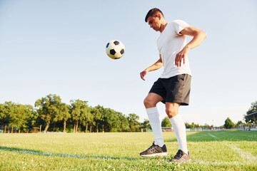 Summer daytime. Young soccer player have training on the sportive field