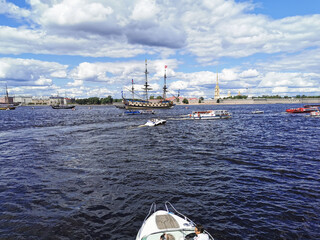 A yacht with a female captain goes to the Neva River to look at warships and sailboats for the Day...