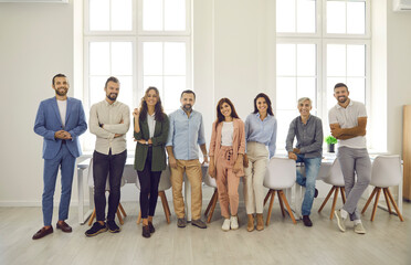 Group portrait of happy multi aged business people at work. Team of successful young and mature...