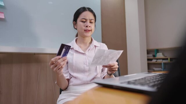 Asian young woman feeling stress because of her overdue credit card statement, financial problem debt, paying bills salary woman, struggle with financial situation, credit card debt, shopaholic karma