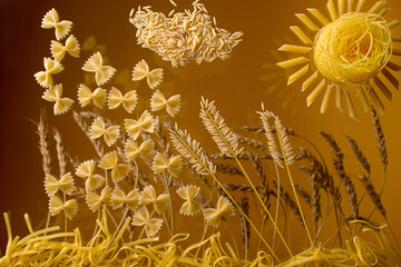 wheat, pasta and sun on brown background 