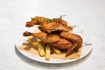 There is a whole roast chicken on the table