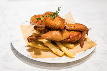 There is a whole roast chicken on the table