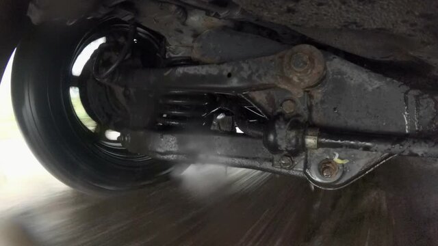 Car Suspension System On Puddle And Wet Surface