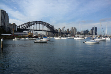 Naklejka premium Beautiful scenic view of Sydney City Center, Harbour Bridge, Luna Park, boats and yachts from Lavender Bay. 