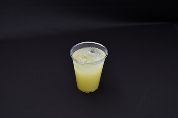 Lime juice against a plain black background