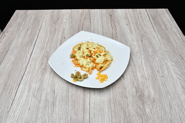 Pasta kept on a wooden table against a plain black background