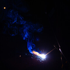 Welding flame while working with a semi-automatic welder.