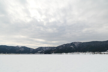 Landscape of snow-covered plains in Shiga Prefecture, Japan in mid-winter.