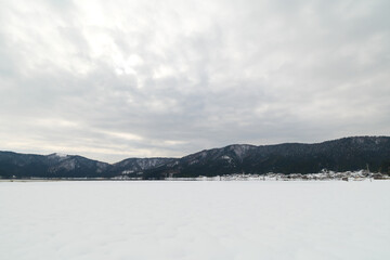 Fototapeta na wymiar Landscape of snow-covered plains in Shiga Prefecture, Japan in mid-winter.