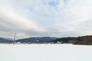 Landscape of snow-covered plains in Shiga Prefecture, Japan in mid-winter.