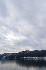 A view of Lake Yogo in Shiga Prefecture in midwinter, with the sky reflecting off the lake surface.