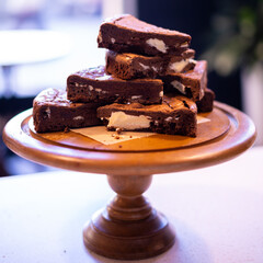 A stack of chocolate brownies on wooden background, homemade bakery and dessert