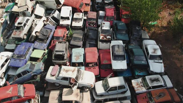 Aerial view of the Soviet car dump. 4K shooting from above on piles of rusting cars.