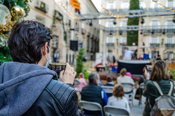 Person Recording Video of a Street Theater Show with Mobile Phone