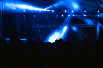 Fototapeta na wymiar Concert background. Blue and foggy spotlights on the stage.
