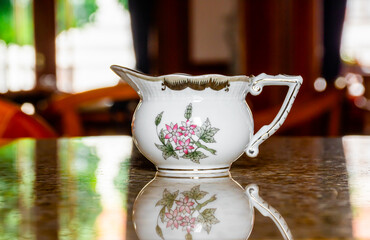 Elegant Herend porcelain milk pourer in a cafe.