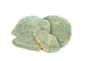 Out of date green moldy bread slices on white background. Out of date usage concept. 