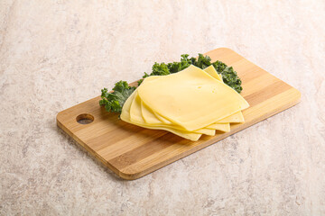 Sliced Gouda cheese over board