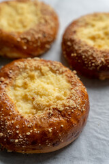 Bakery pastries on white background. Freshly cooked bakery. Home cooked bakery for morning breakfast. Copy space. Vertical shot. Selective focus