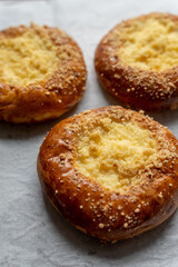 Bakery pastries on white background. Freshly cooked bakery. Home cooked bakery for morning breakfast. Copy space. Vertical shot. Selective focus