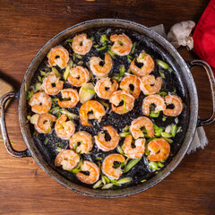 Fried shrimps in a vintage pan, top view