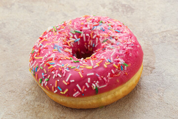 Sweet glazed struwberry donut with icing