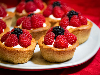 Freshly baked baskets with curd cream and strawberries