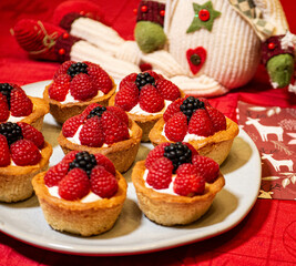 Freshly baked baskets with curd cream and strawberries