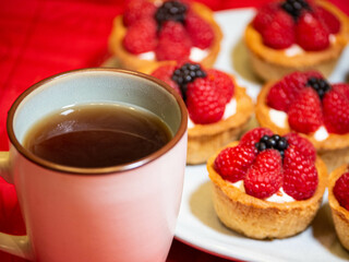 Freshly baked baskets with curd cream and strawberries