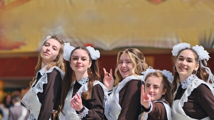 Happy Russian female graduates pose on their graduation day.