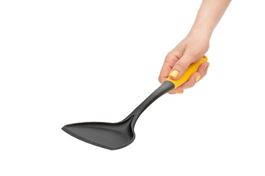Woman's hand holding plastic spade for preparation food.