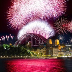Sydney city harbour bridge illuminated with vivid colours from NYE New Years Eve fireworks NSW...