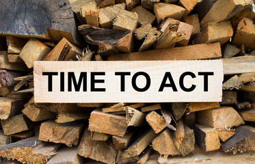 Wall firewood. Background of dry chopped firewood logs in a pile and plate with text Time To Act
