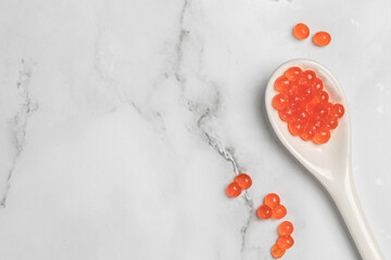 Red caviar in spoon and caviar on light background. Close-up salmon caviar. Delicatessen. Gourmet food. Seafood. appetizer, selective focus, place for text