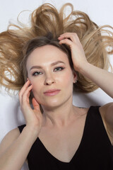 Naklejka premium studio portrait of a girl with long blonde hair