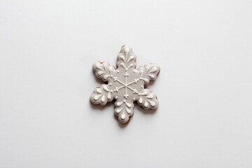 Gingerbread cookie in snowflake shape isolated on white background