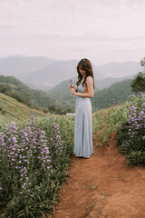 Portrait of thai young woman enjoying in blooming flower field