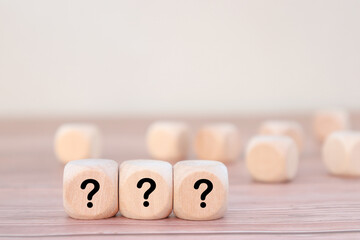 Wooden cubes with question mark icons in a row. question mark 
