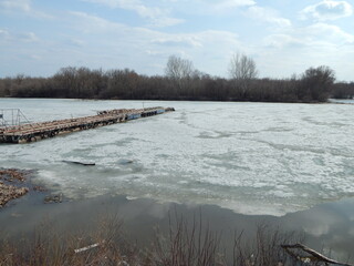 The boat dock was frozen in winter. Frozen pontoon on the river.  - 479155849