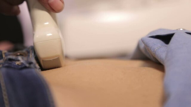 Doctor do ultrasound devices monitor diagnostic to a woman patient. Sonography. The patient's belly. Close up