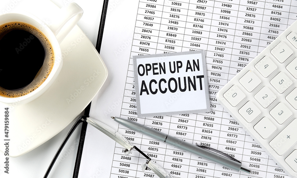 Aufkleber open up an account text on sticky on the chart with coffee,pen and calculator