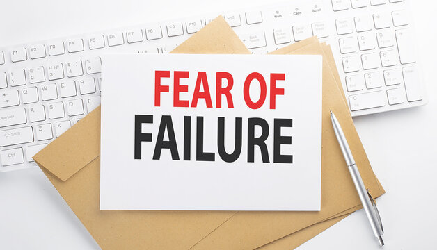 Text FEAR OF FAILURE on the envelope on the keyboard