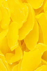Dried yellow mangoes for proper nutrition scattering closeup top view