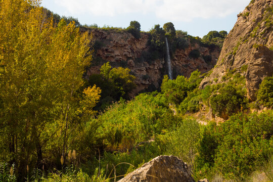 Majestic Greenery, Cliffs and Water Cascade Of The Legendary Salto De La Novia Waterfall In Navajas, Castellon, Spain